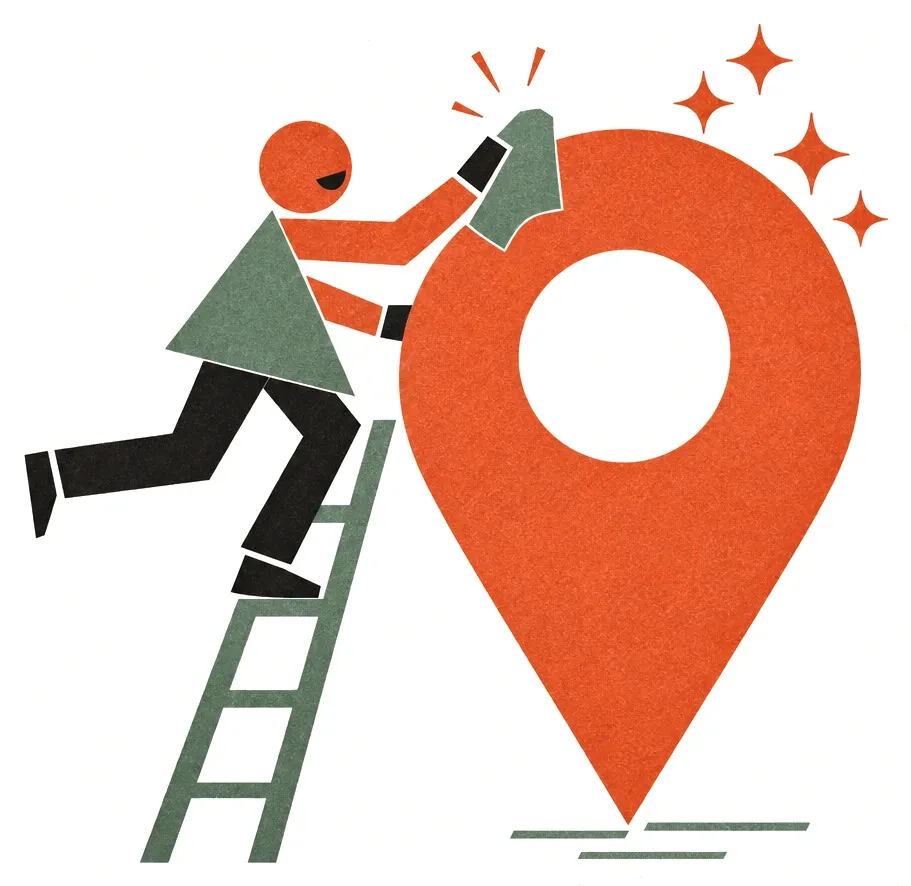 A worker on a ladder polishing a giant map pin until it sparkles